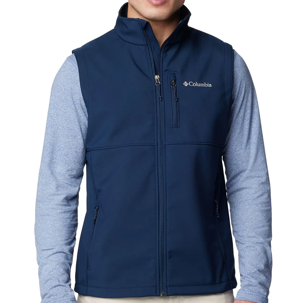 Navy blue vest with Columbia logo worn over a light gray long-sleeve shirt on a white background
