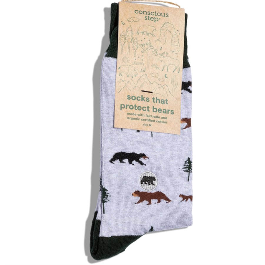Socks with bear design and 'conscious step' packaging on a white background