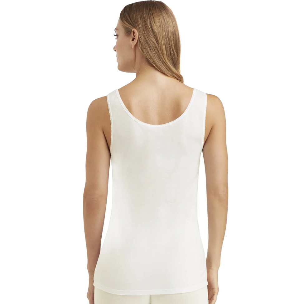 Woman wearing a white tank top on a white background