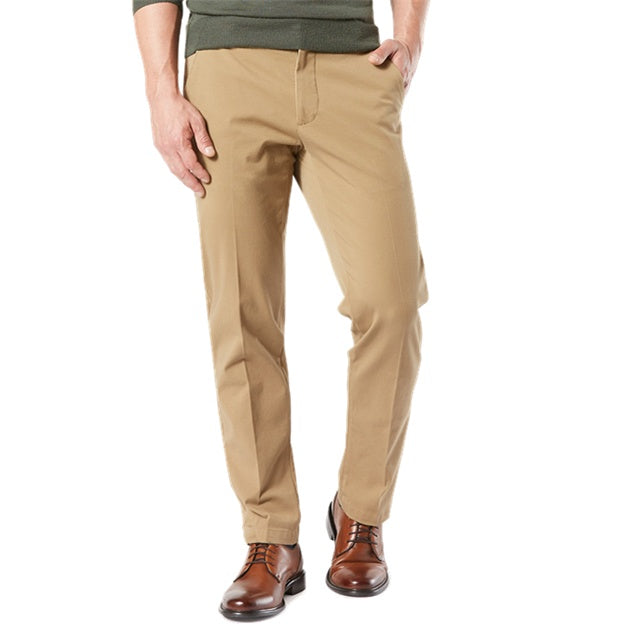 Beige pants worn by a person on a white background