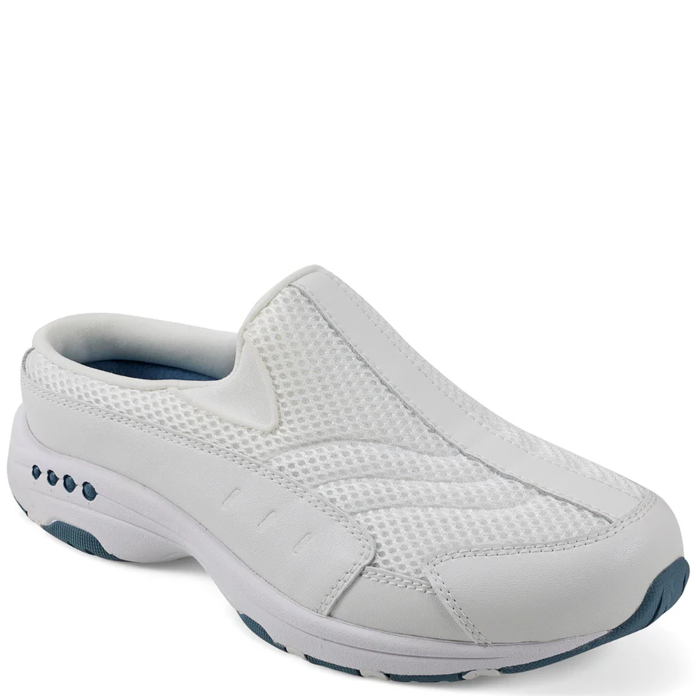 White slip-on shoe with blue accents on a white background