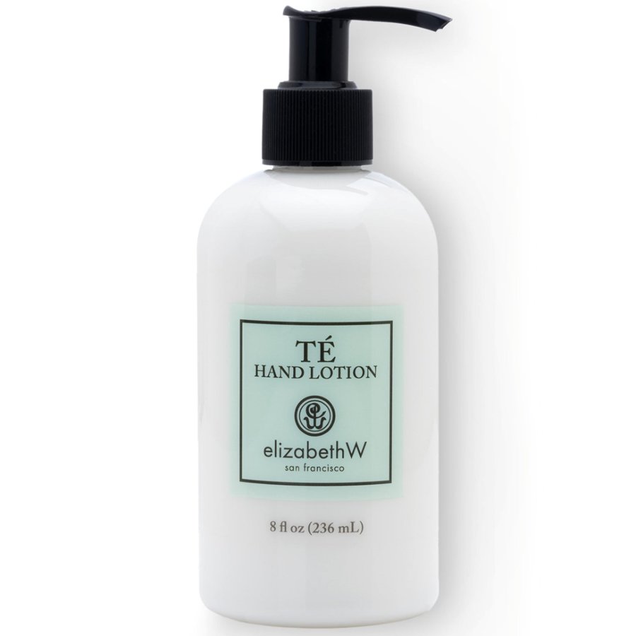 White bottle of Té Hand Lotion with black pump on a white background