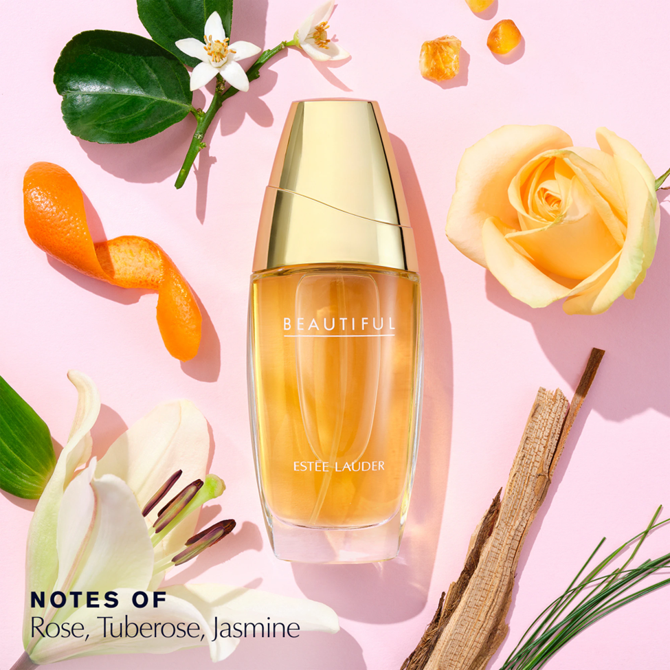 Estée Lauder Beautiful perfume bottle with flowers on a pink background