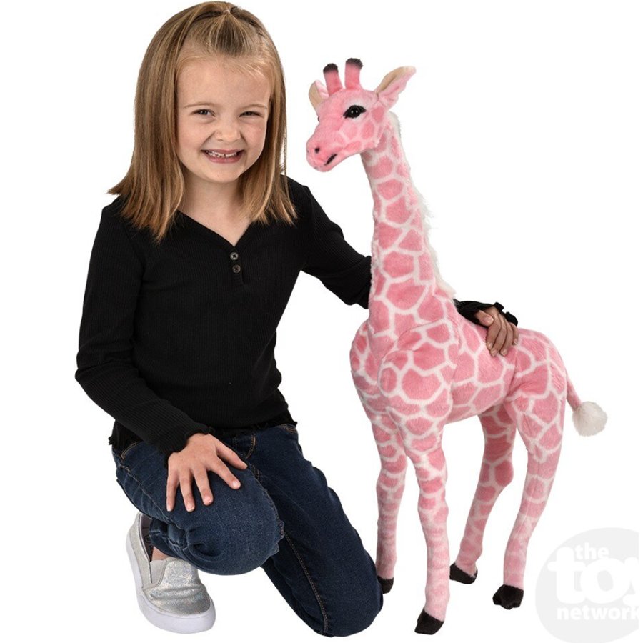 Child with a large pink stuffed giraffe on a white background