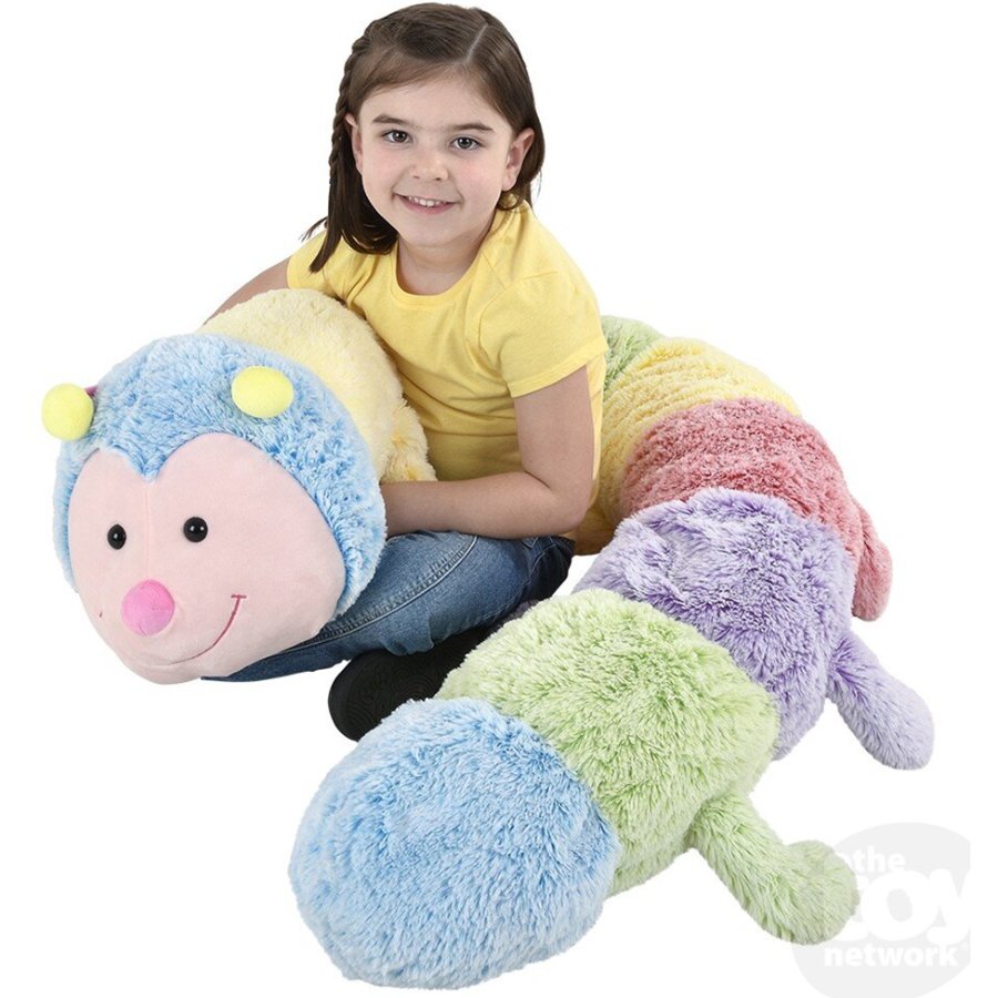 Child with a large, colorful caterpillar plush toy on a white background