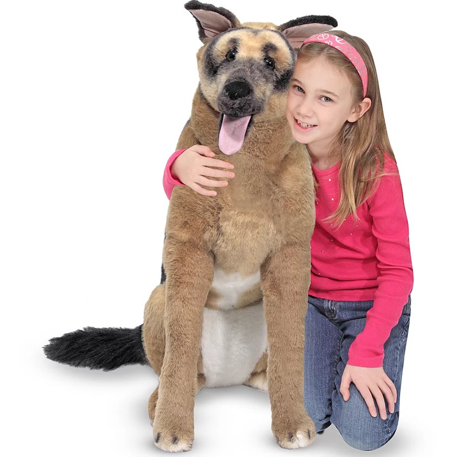 Girl hugging a large plush German Shepherd dog on a white background