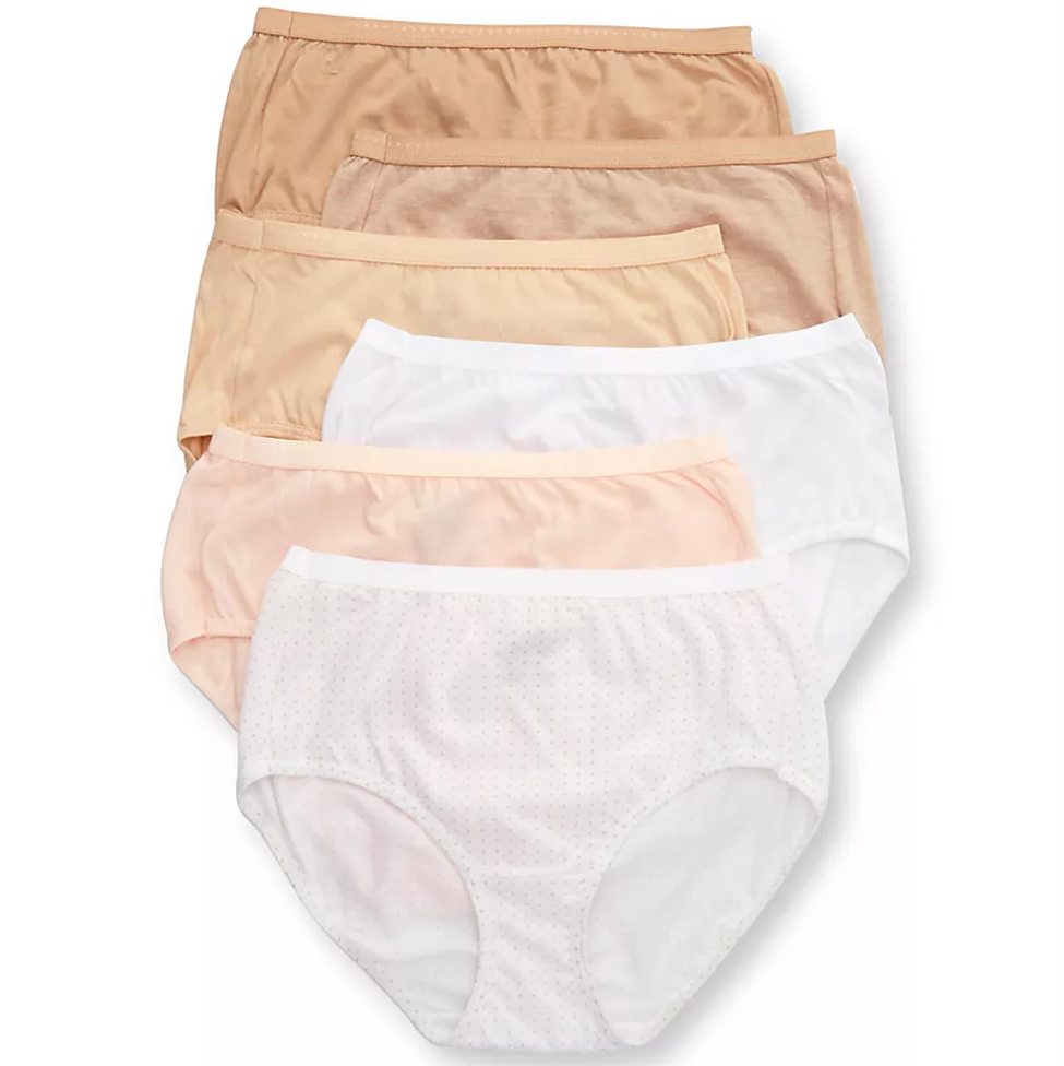 Set of women's underwear in beige, peach, and white on a white background