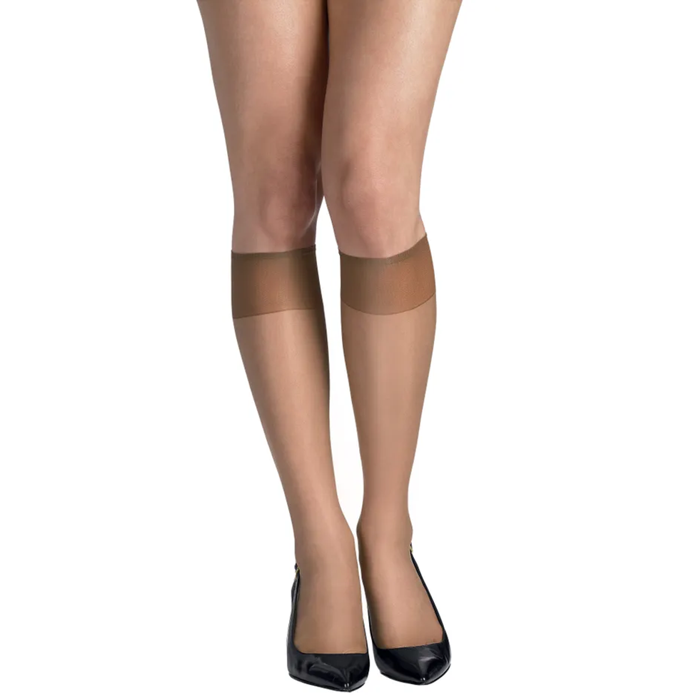 Beige sheer stockings worn with black shoes on a white background