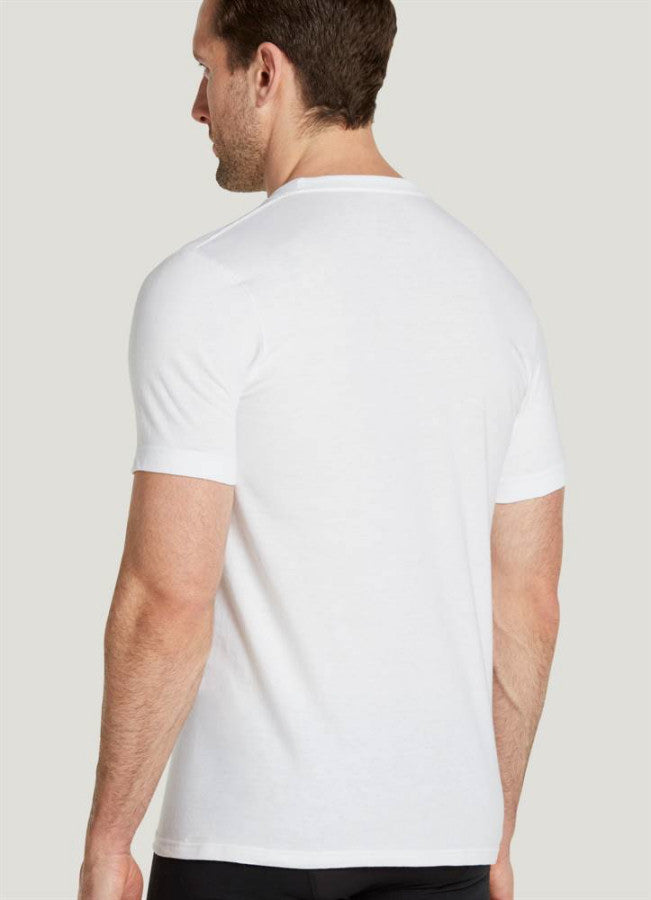 Man wearing a plain white t-shirt on a light gray background