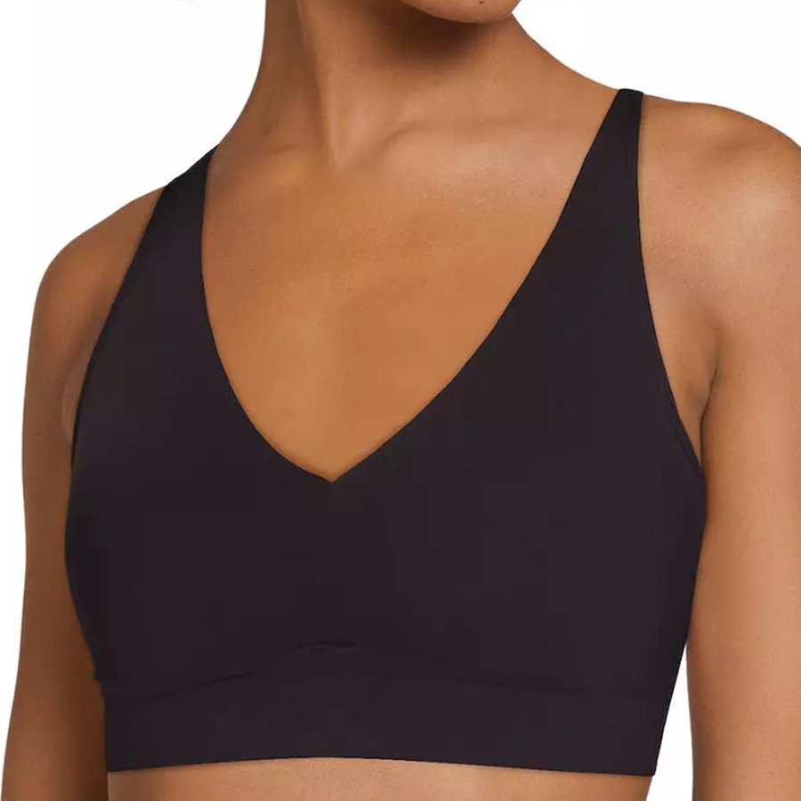 Black sports bra worn by a person on a white background
