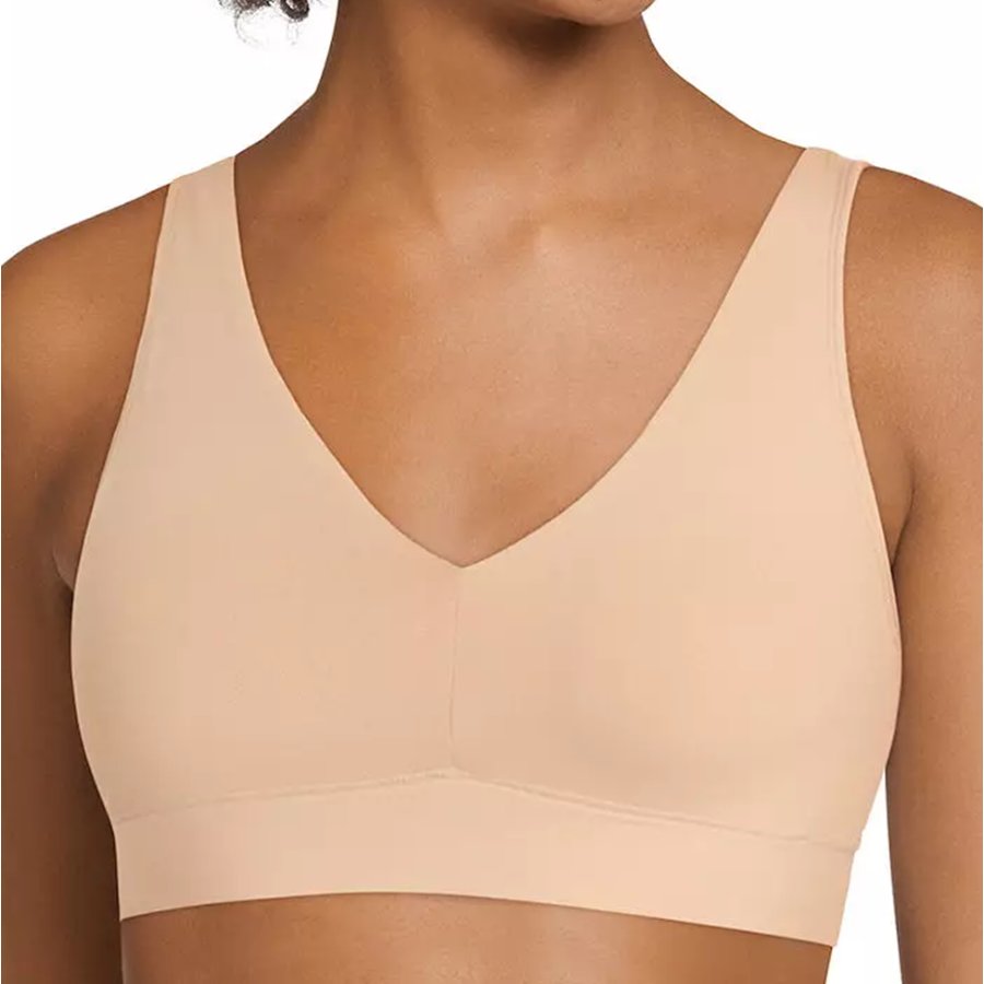 Beige bra on a model with a plain background
