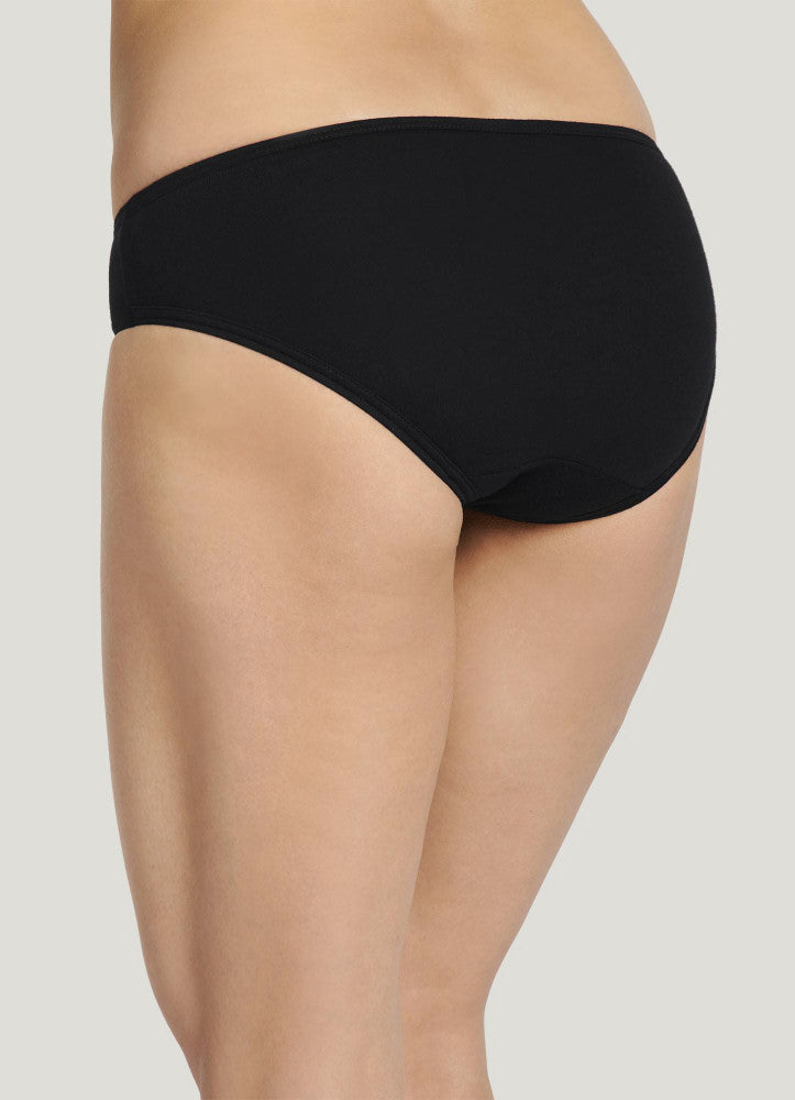 Black underwear worn by a person on a light gray background
