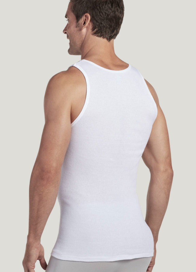 Man wearing a white tank top against a plain background