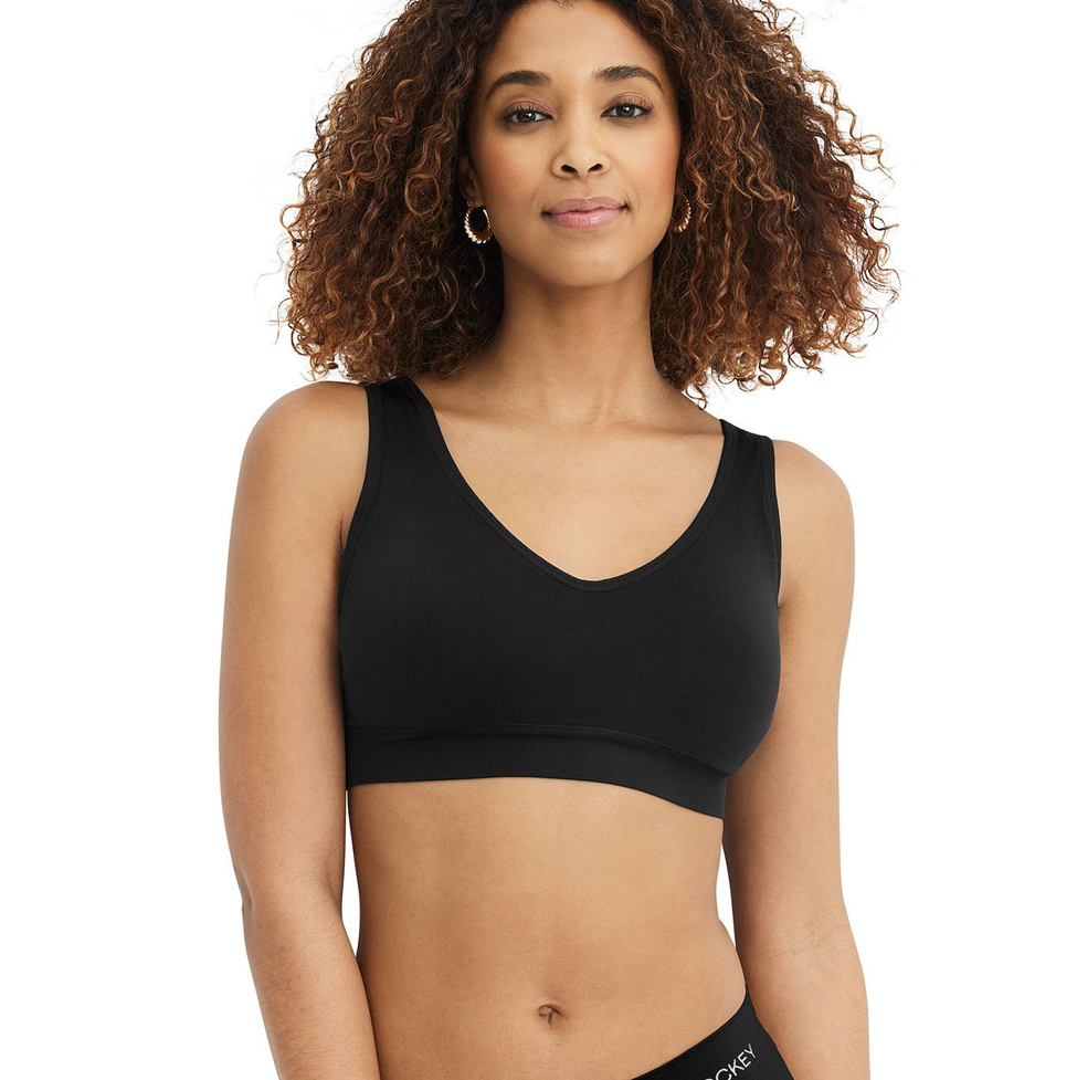 Woman wearing a black sports bra on a white background