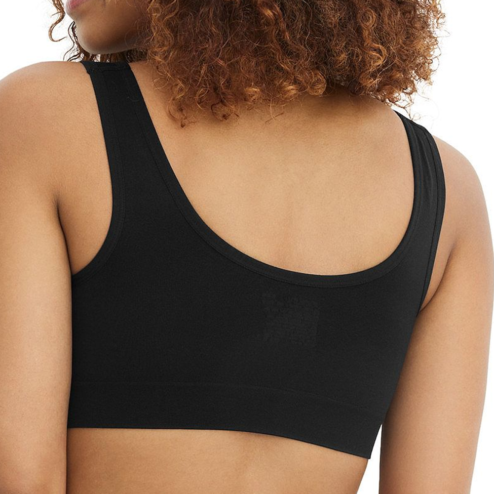 Black sports bra worn by a person on a white background