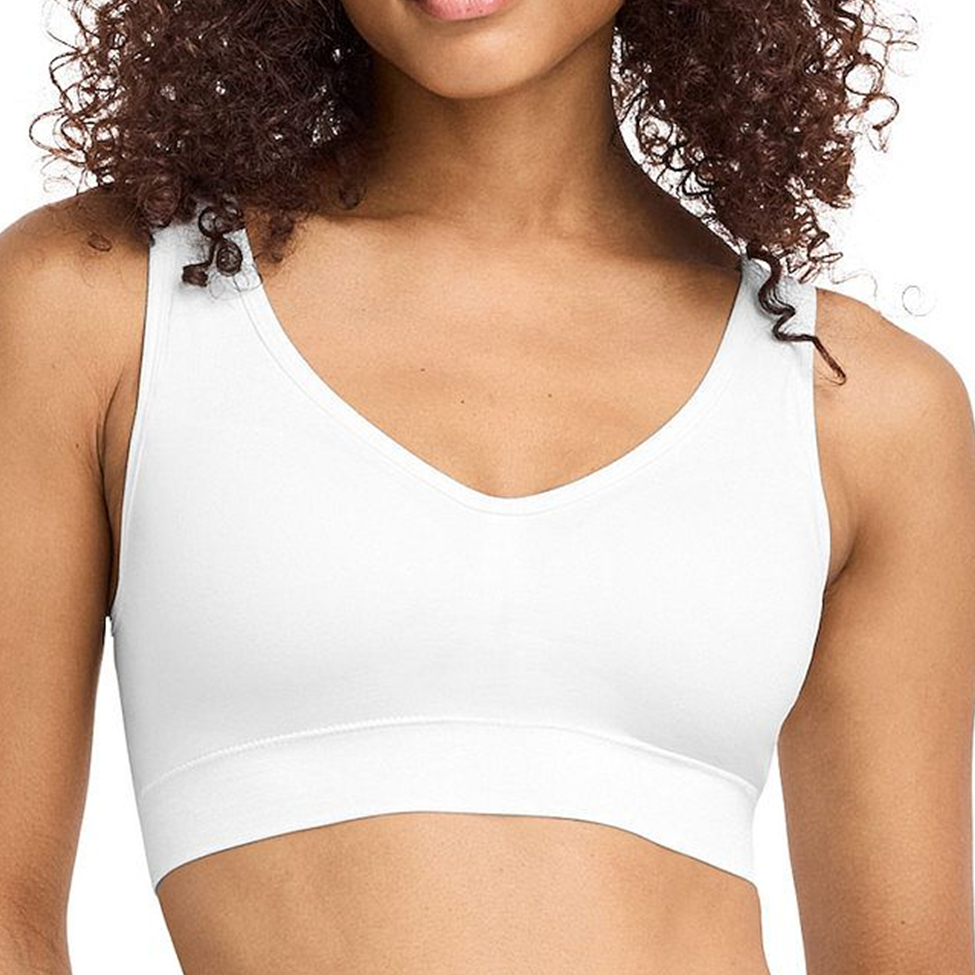 White sports bra worn by a person with a neutral background