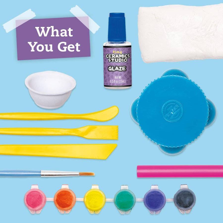 Ceramics studio glaze kit with glaze bottles, brushes, and tools on a blue background