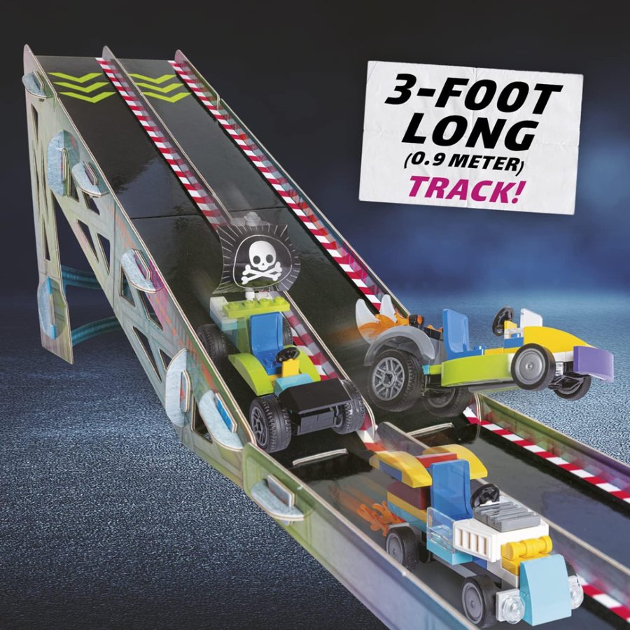 Toy race track set with cars and a sign indicating its length on a dark background.