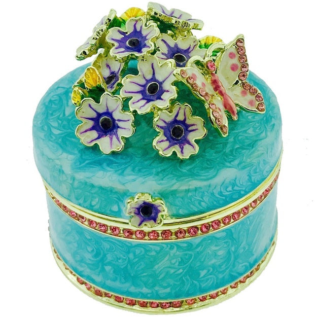 Decorative blue box with floral and butterfly designs on a white background