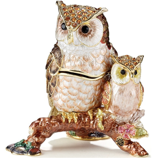 Decorative owl figurine with gemstones on a white background