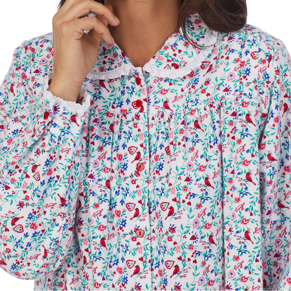 Floral patterned shirt with red birds and flowers on a white background