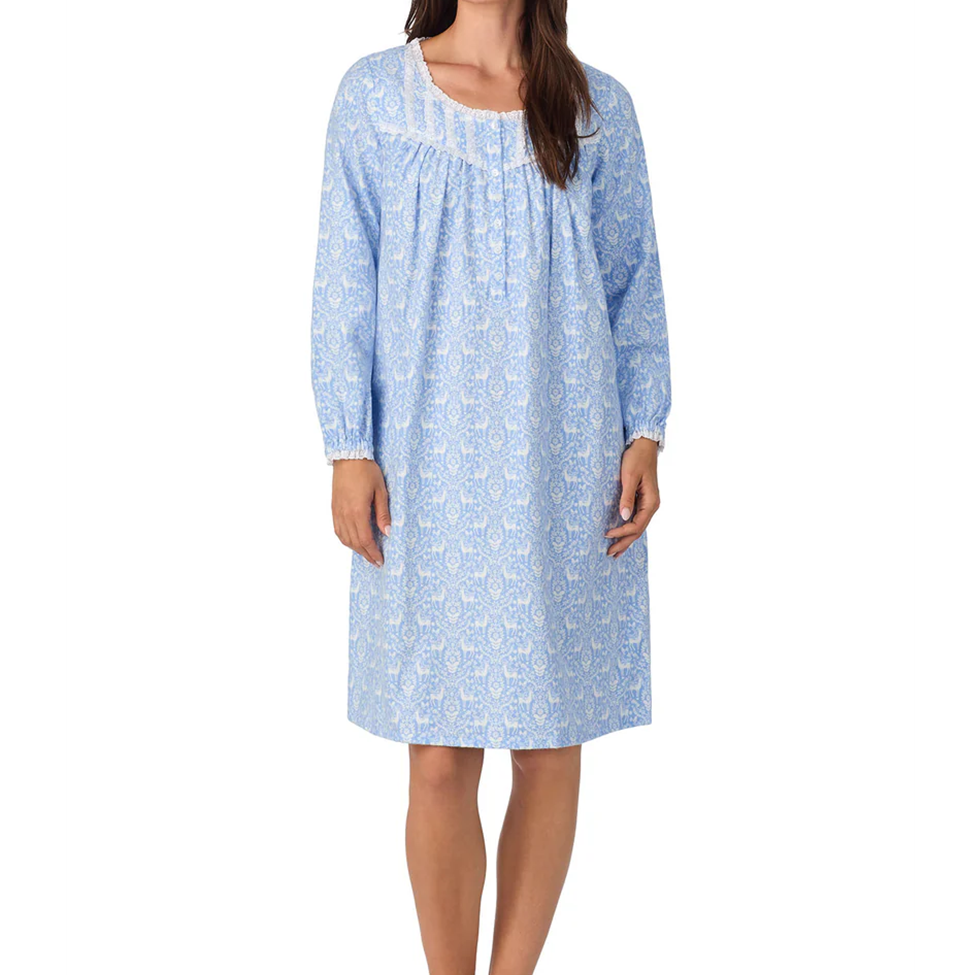 Woman wearing a blue floral nightgown on a white background