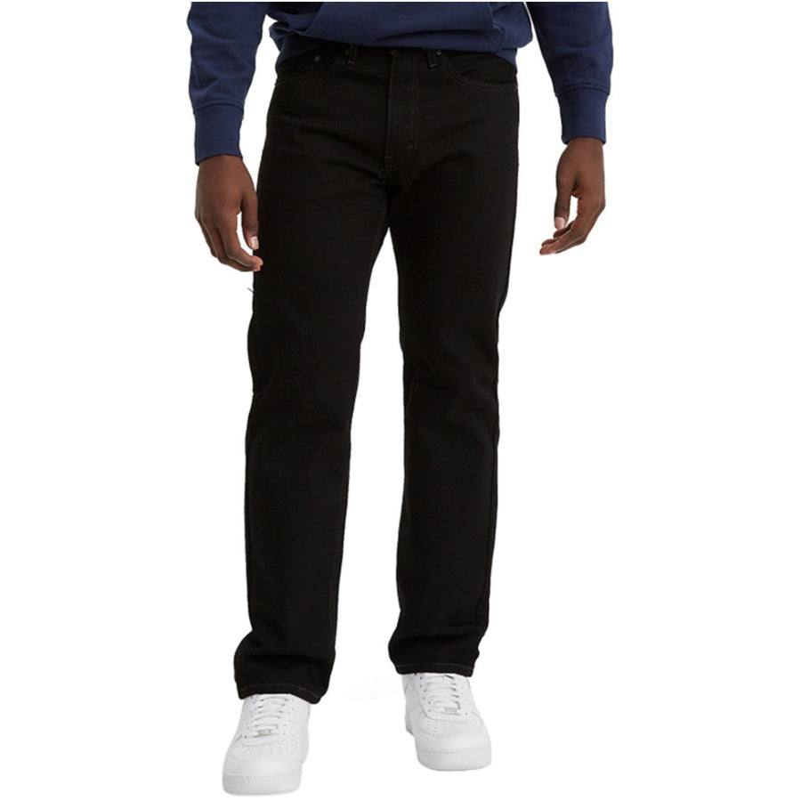 Person wearing black jeans and a blue shirt on a white background