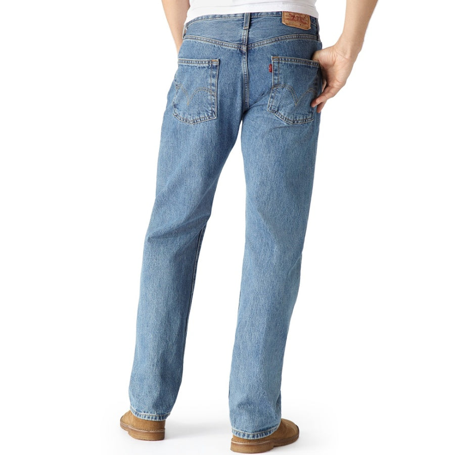 Blue jeans worn by a person on a white background