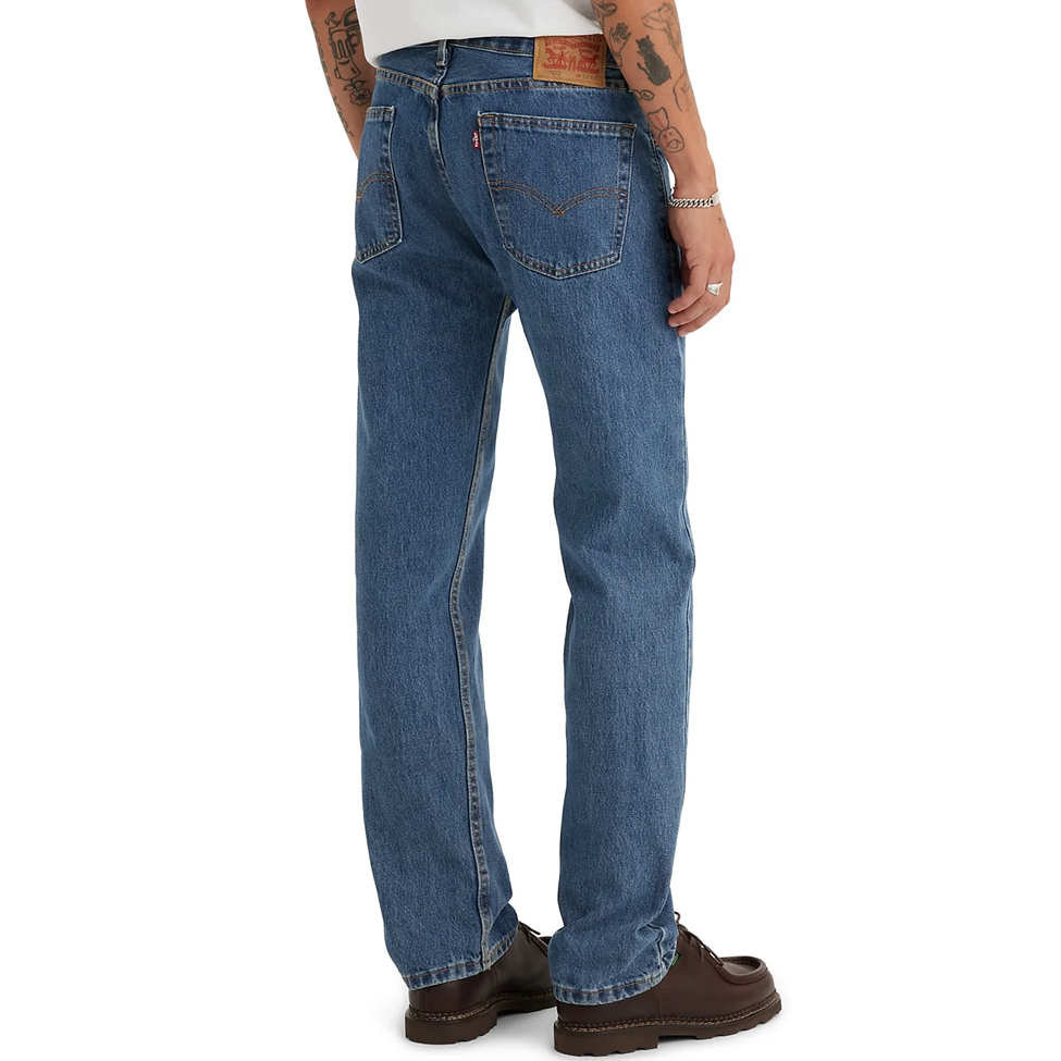Person wearing blue jeans on a white background