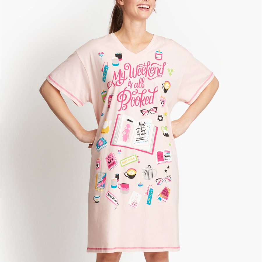 Woman wearing a pink nightshirt with colorful graphics and text on a white background
