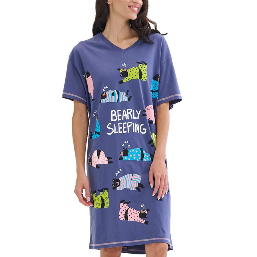 Woman wearing a blue nightshirt with bear illustrations and 'BEARLY SLEEPING' text on a white background