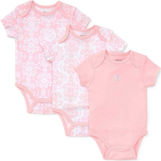 Three baby bodysuits with different patterns on a white background