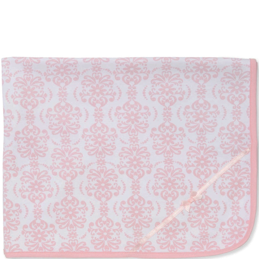 Pink and white patterned blanket on a white background