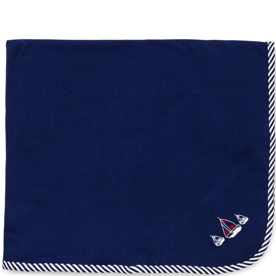 Navy blue blanket with sailboat designs on a white background