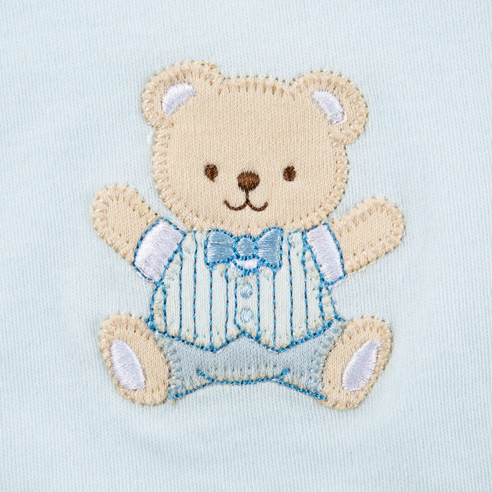 Embroidered teddy bear patch on a light blue background