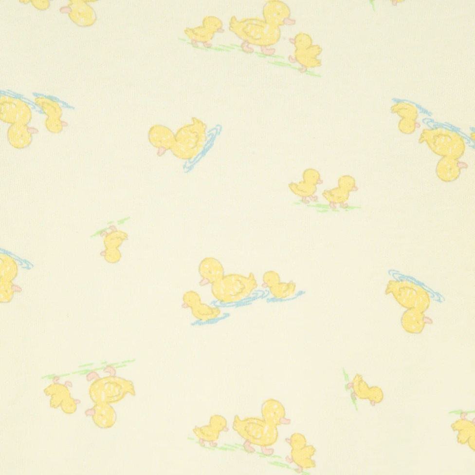 Pattern of yellow ducklings on a light beige background