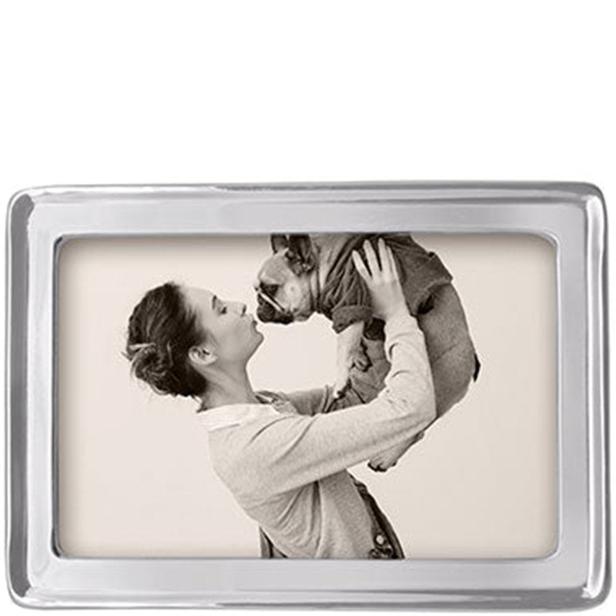Rectangular photo frame with a black and white photo of a woman holding a child.