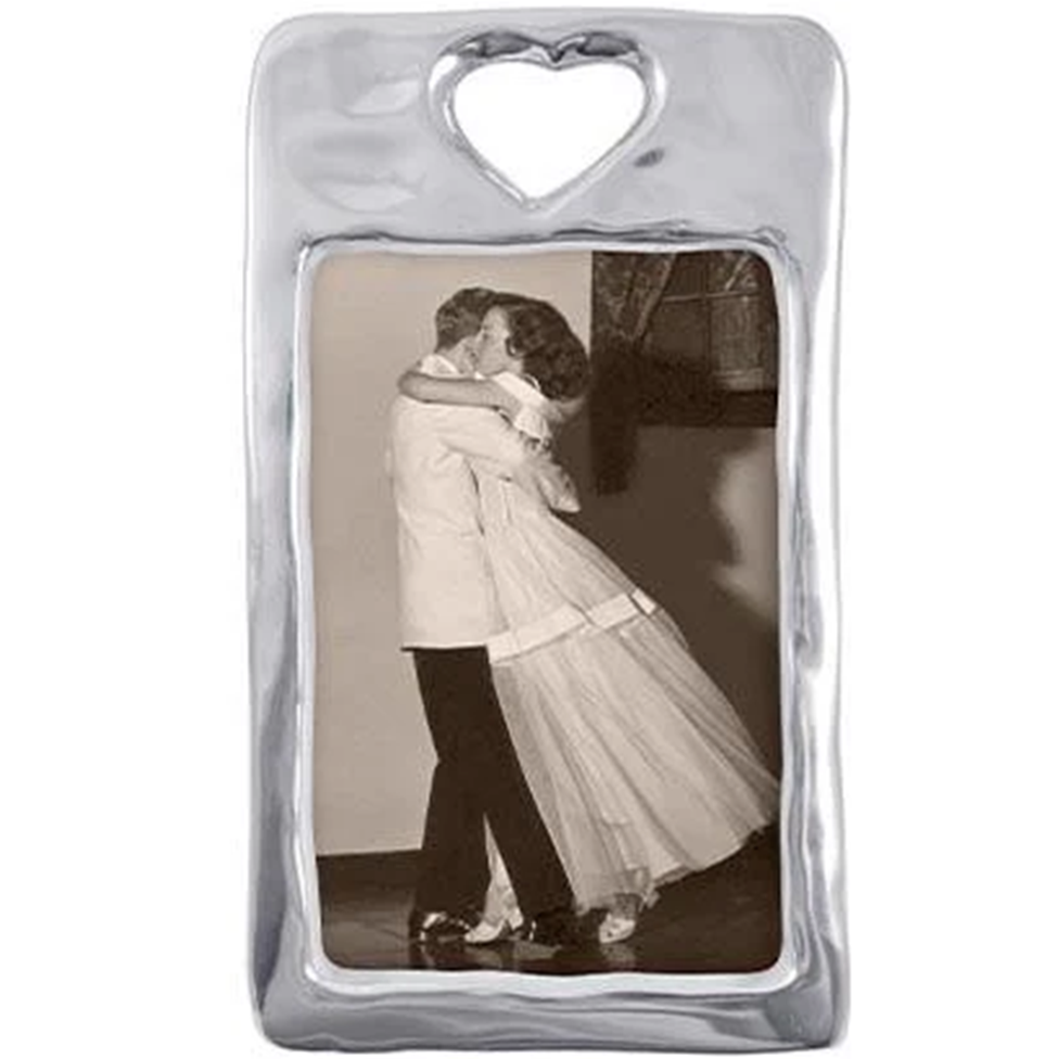 Heart-shaped photo frame with a black and white photo of a couple embracing.
