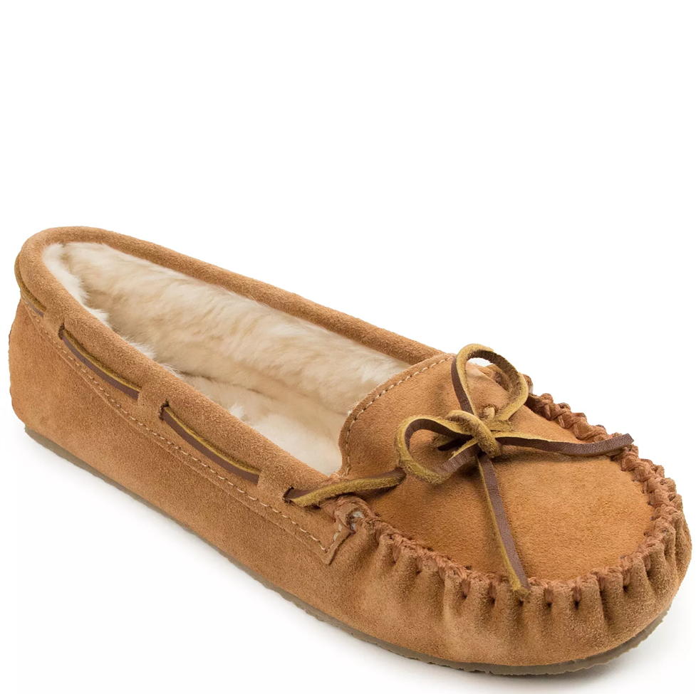 Brown moccasin slipper with fur lining on a white background