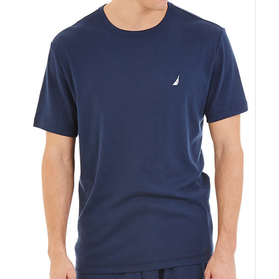 Person wearing a navy blue t-shirt with a small logo on a white background