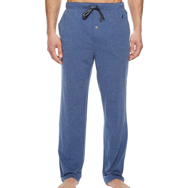 Blue pajama pants worn by a person on a white background