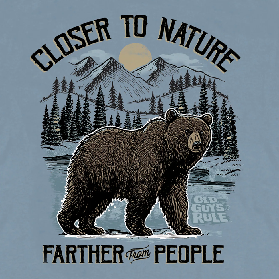 T-shirt design with bear, mountains, and text 'Closer to Nature, Farther from People' on a light blue background.