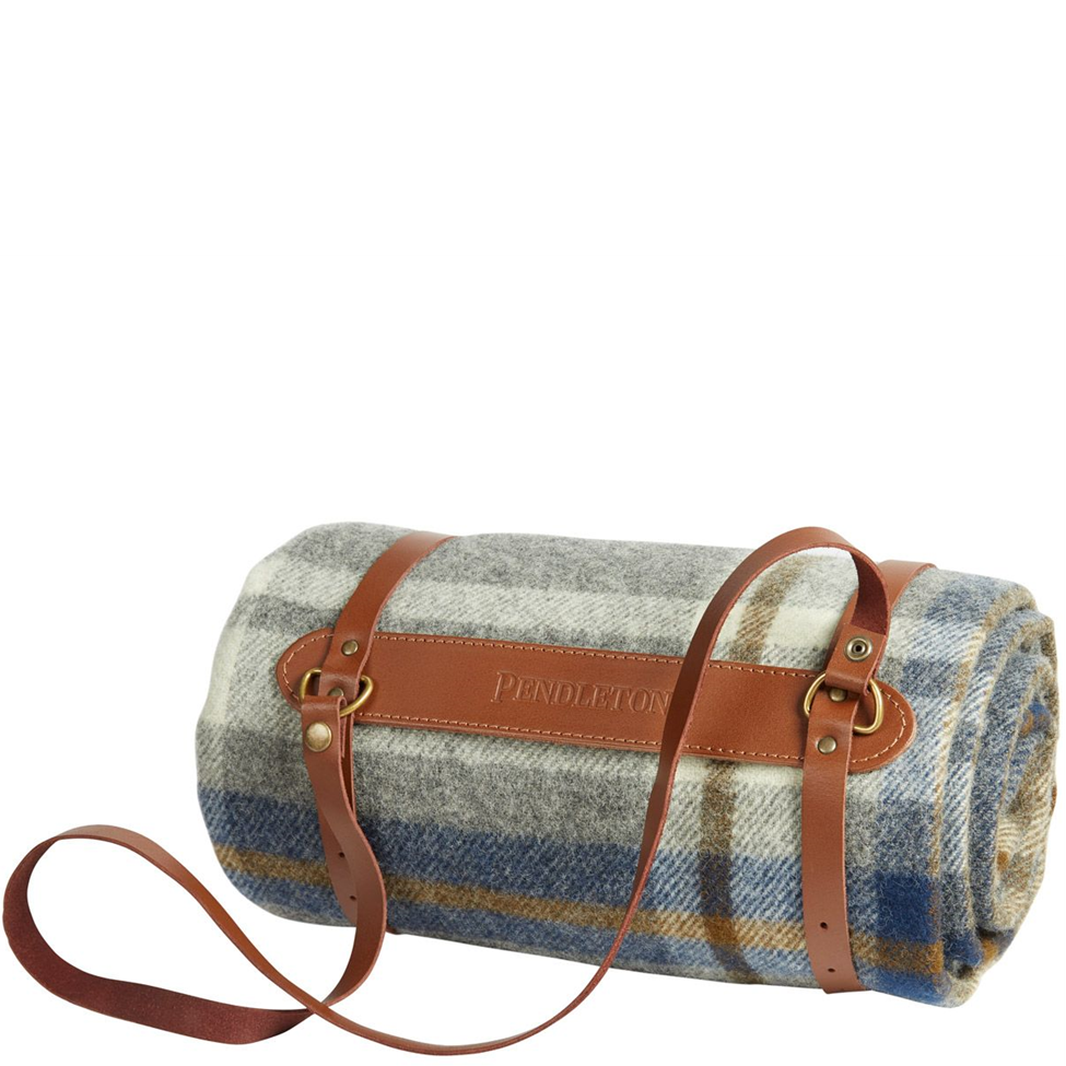 Roll-up picnic blanket with plaid pattern and brown leather strap on a white background