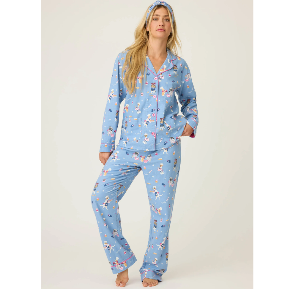 Woman wearing a blue pajama set with a pattern on a white background