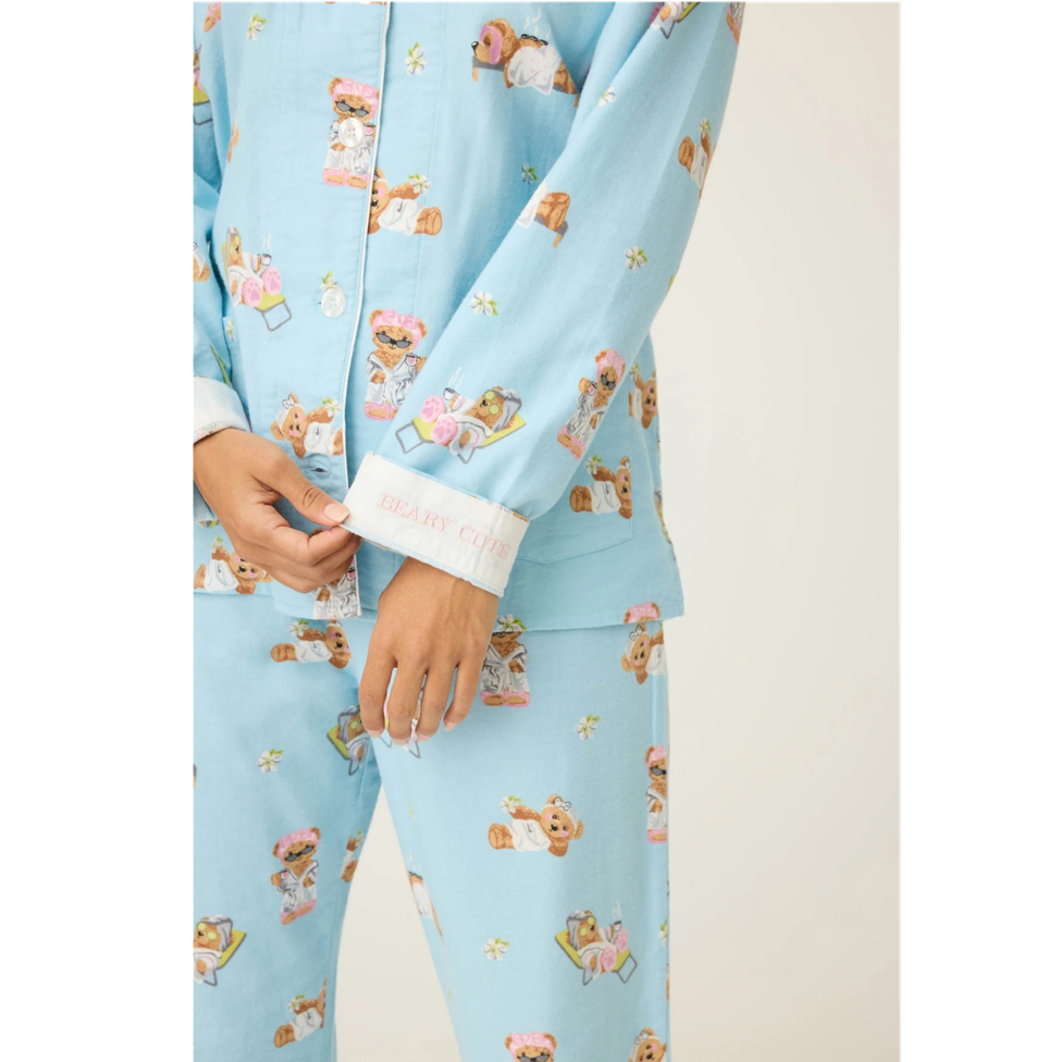 Light blue pajama set with teddy bear pattern on a white background