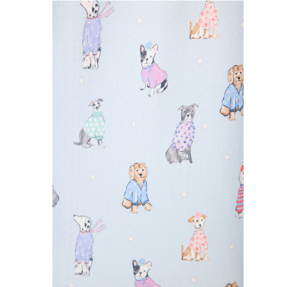 Pattern of dogs in colorful outfits on a light blue background