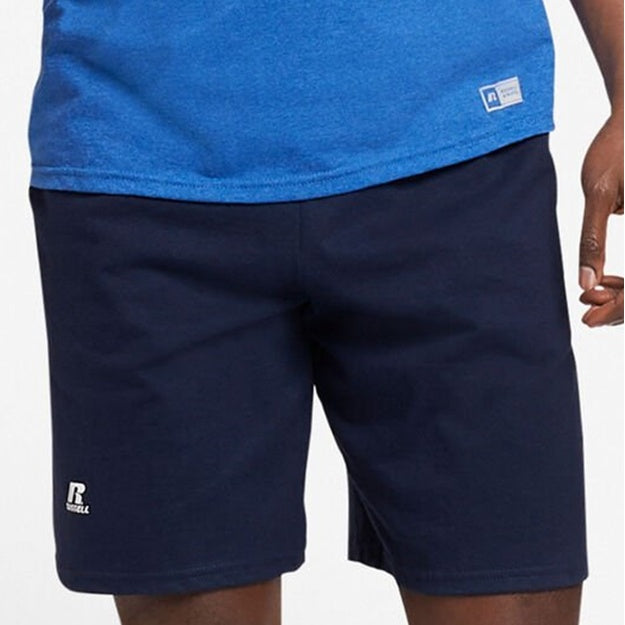 Navy shorts worn with a blue top on a white background