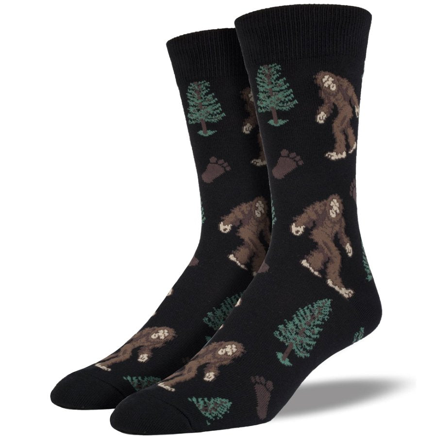 Black socks with bear and tree pattern on a white background