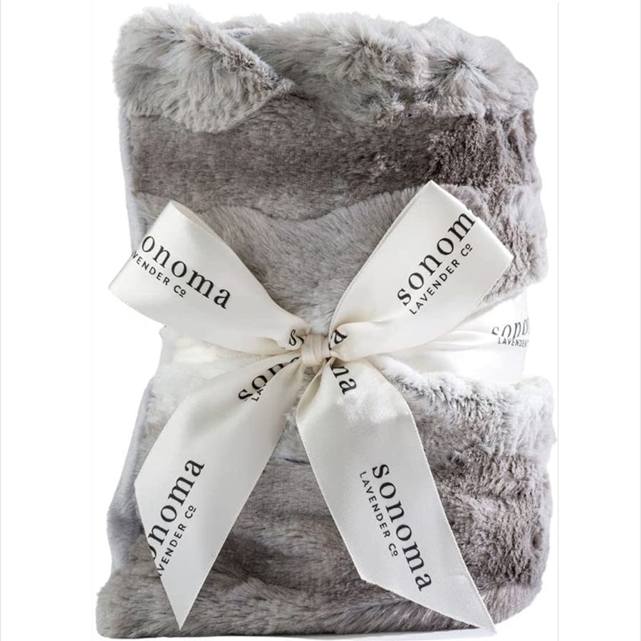 Gray plush blanket with a white ribbon and 'Sonoma Lavender Co.' branding on a white background