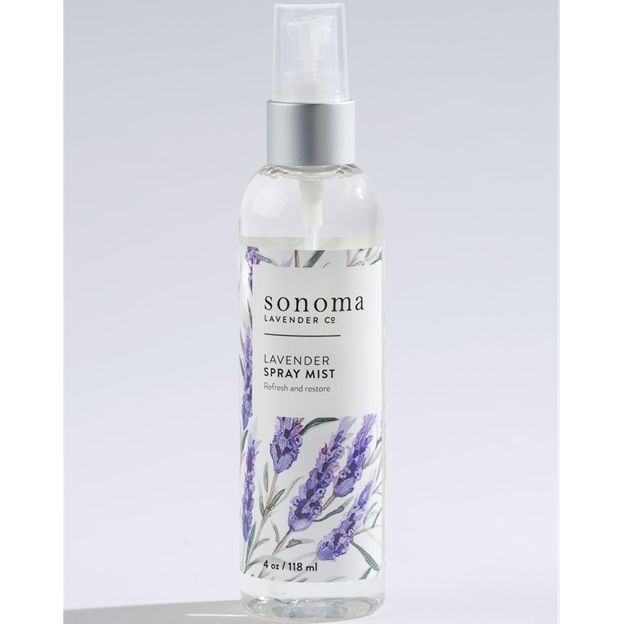 Lavender spray mist bottle with floral design on a light gray background